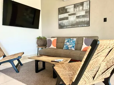 a living room with a couch and a table at Casa de lujo- Vista- Piscina- La Libertad in La Libertad