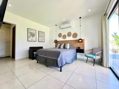 a bedroom with a bed and a chair at Casa de lujo- Vista- Piscina- La Libertad in La Libertad