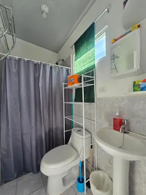 a bathroom with a toilet and a sink at Casa en Villa Panamericana, San Miguel in San Miguel
