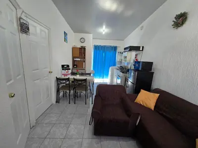 a living room with a couch and a table with chairs at Casa en Villa Panamericana, San Miguel in San Miguel