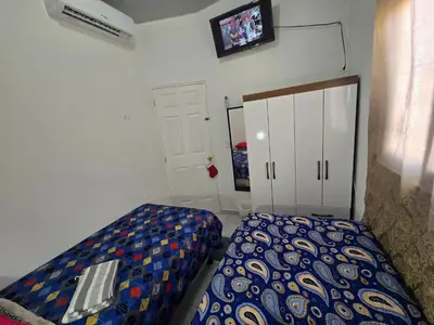 a small bedroom with a bed and a cabinet at Casa en Villa Panamericana, San Miguel in San Miguel
