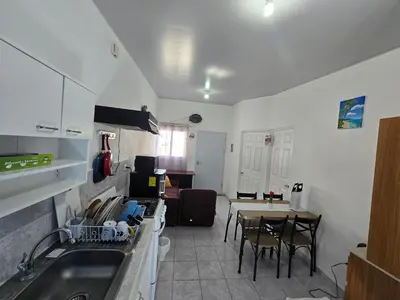 a kitchen with a sink and a table with chairs at Casa en Villa Panamericana, San Miguel in San Miguel