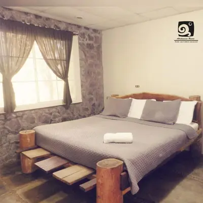 a bedroom with a bed with a wooden frame and a window at Atlakamani Surf in Chirilagua