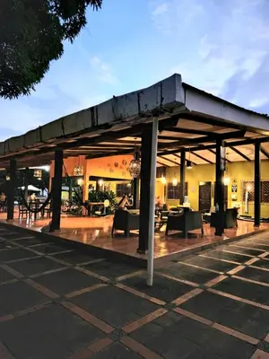 a pavilion with tables and chairs in a parking lot at Atlakamani Surf in Chirilagua