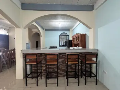 a kitchen with a bar with stools in a room at Estancia Altos de Guadalupe in Alegría