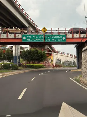a bridge over a road with a sign on it at Chavez in San Salvador