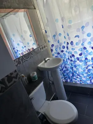 a bathroom with a white toilet and a sink at Chavez in San Salvador