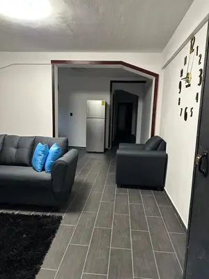 a living room with a couch and two chairs at Chavez in San Salvador