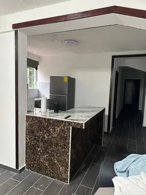 a kitchen with a granite counter top in a room at Chavez in San Salvador
