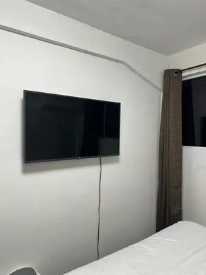 a flat screen tv on a wall in a bedroom at Chavez in San Salvador