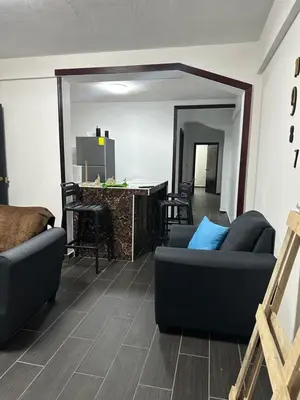 a living room with two couches and a bar at Chavez in San Salvador