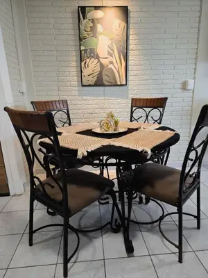 a dining room table with four chairs around it at Cozy & Modern Condo In the Heart of San Salvador in San Salvador
