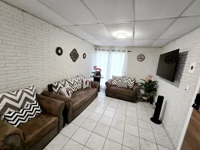 a living room with two couches and a tv at Cozy & Modern Condo In the Heart of San Salvador in San Salvador