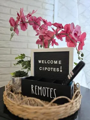 a basket filled with books and flowers on a table at Cozy & Modern Condo In the Heart of San Salvador in San Salvador