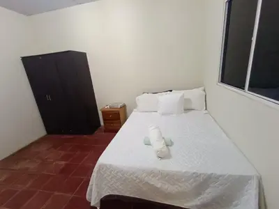 a bedroom with a bed with two candles on it at Casa Blanca el Zonte in El Zonte