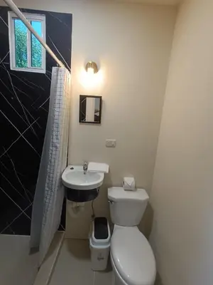 a bathroom with a toilet and a sink at Casa Blanca el Zonte in El Zonte