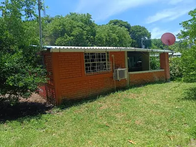 a small red brick building with a basketball at Casa Blanca el Zonte in El Zonte