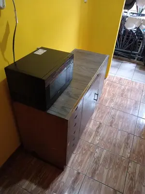 a television sitting on top of a wooden cabinet at Rooms libertad in San Salvador