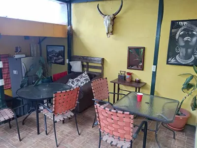 a restaurant with two tables and a cow skull on the wall at Rooms libertad in San Salvador