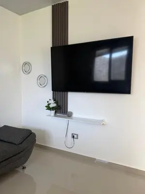 a living room with a flat screen tv on a wall at Descanso San Miguel in San Miguel