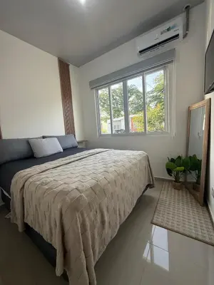 a bedroom with a large bed and a window at Descanso San Miguel in San Miguel