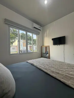 a bedroom with a bed and a flat screen tv at Descanso San Miguel in San Miguel