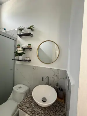 a bathroom with a sink and a mirror and a toilet at Descanso San Miguel in San Miguel