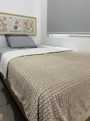 a bedroom with a large bed with a blanket at Descanso San Miguel in San Miguel
