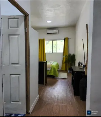 a room with a bedroom with a bed and a door at Suite para dos Las Terrazas in San Salvador