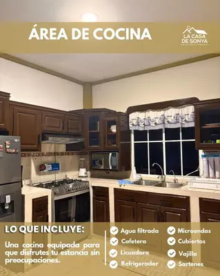 a kitchen with wooden cabinets and a sign for an area be cocina at La Casa de Sonya in Concepción de Ataco