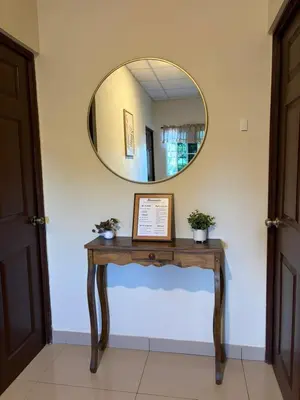 a table with a mirror on a wall at La Casa de Sonya in Concepción de Ataco