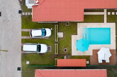 two cars parked next to a swimming pool at Jasibe Oceanside in Amatecampo - Steps to beach - Flexible Checkout in El Porvenir
