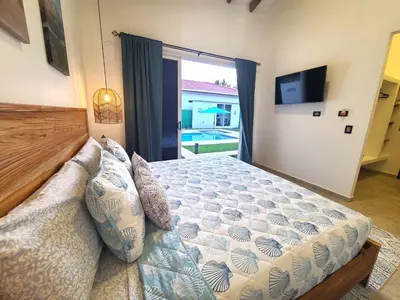 a bedroom with a bed and a large window at Jasibe Oceanside in Amatecampo - Steps to beach - Flexible Checkout in El Porvenir
