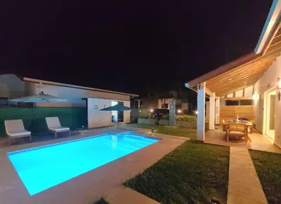 a swimming pool in a yard at night at Jasibe Oceanside in Amatecampo - Steps to beach - Flexible Checkout in El Porvenir