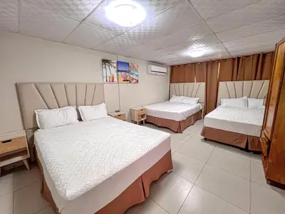 a hotel room with two beds in a room at Quinta Brisas del Surf La Libertad in La Libertad