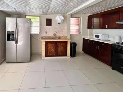 a large kitchen with a stainless steel refrigerator at Quinta Brisas del Surf La Libertad in La Libertad