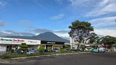 a parking lot with cars parked in front of a building at Apartamento 2-B new suite in SS in San Salvador