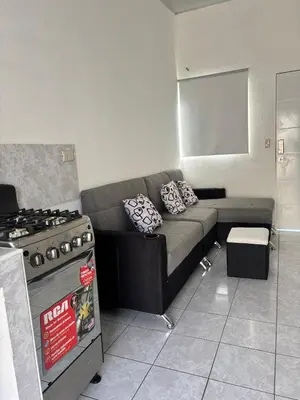 a living room with a couch and a stove at Tu lugar tranquilo cerca de todo in San Miguel