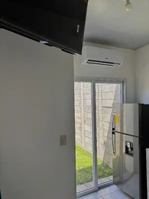 a kitchen with a refrigerator and a window at Tu lugar tranquilo cerca de todo in San Miguel