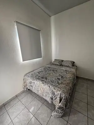 a small bedroom with a bed in the corner at Tu lugar tranquilo cerca de todo in San Miguel