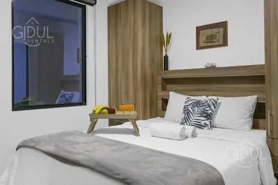 a bedroom with a bed and a table with fruit on it at Stylish apartment in San Salvador Downtown in San Salvador