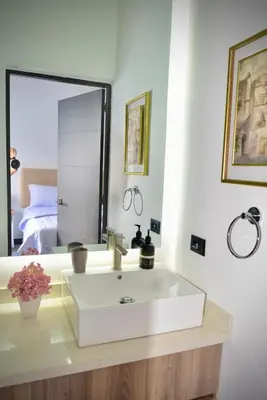 a bathroom with a white sink and a mirror at Stylish apartment in San Salvador Downtown in San Salvador