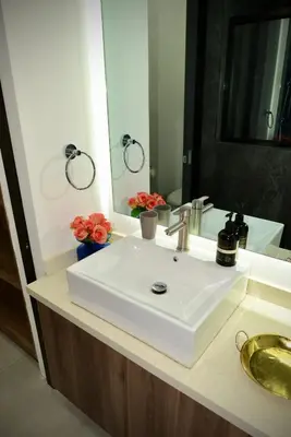 a bathroom with a white sink and a mirror at Stylish apartment in San Salvador Downtown in San Salvador