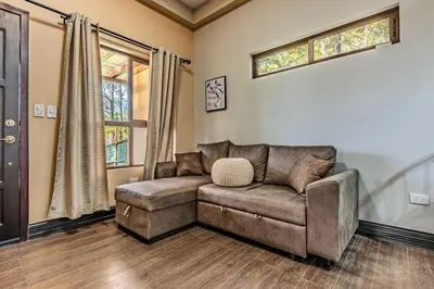 a living room with a couch and a window at Bungalos Vista a Cayaguanca in San Ignacio