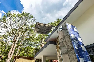 a house with blue solar panels on the side of it at Bungalos Vista a Cayaguanca in San Ignacio