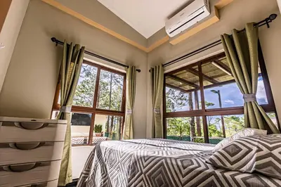 a bedroom with a bed and a large window at Bungalos Vista a Cayaguanca in San Ignacio