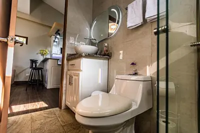 a bathroom with a toilet and a sink and a mirror at Bungalos Vista a Cayaguanca in San Ignacio