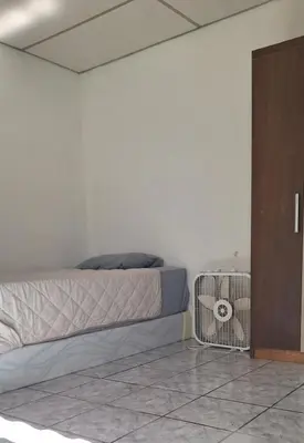 a bedroom with a bed with a cage next to a door at Casa El Trébol