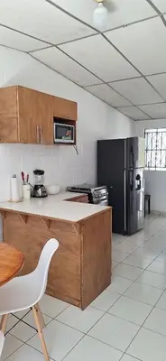 a kitchen with a counter and a refrigerator at Casa El Trébol