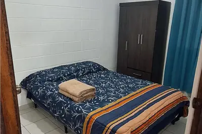 a bedroom with a bed with a towel on it at Casa El Trébol